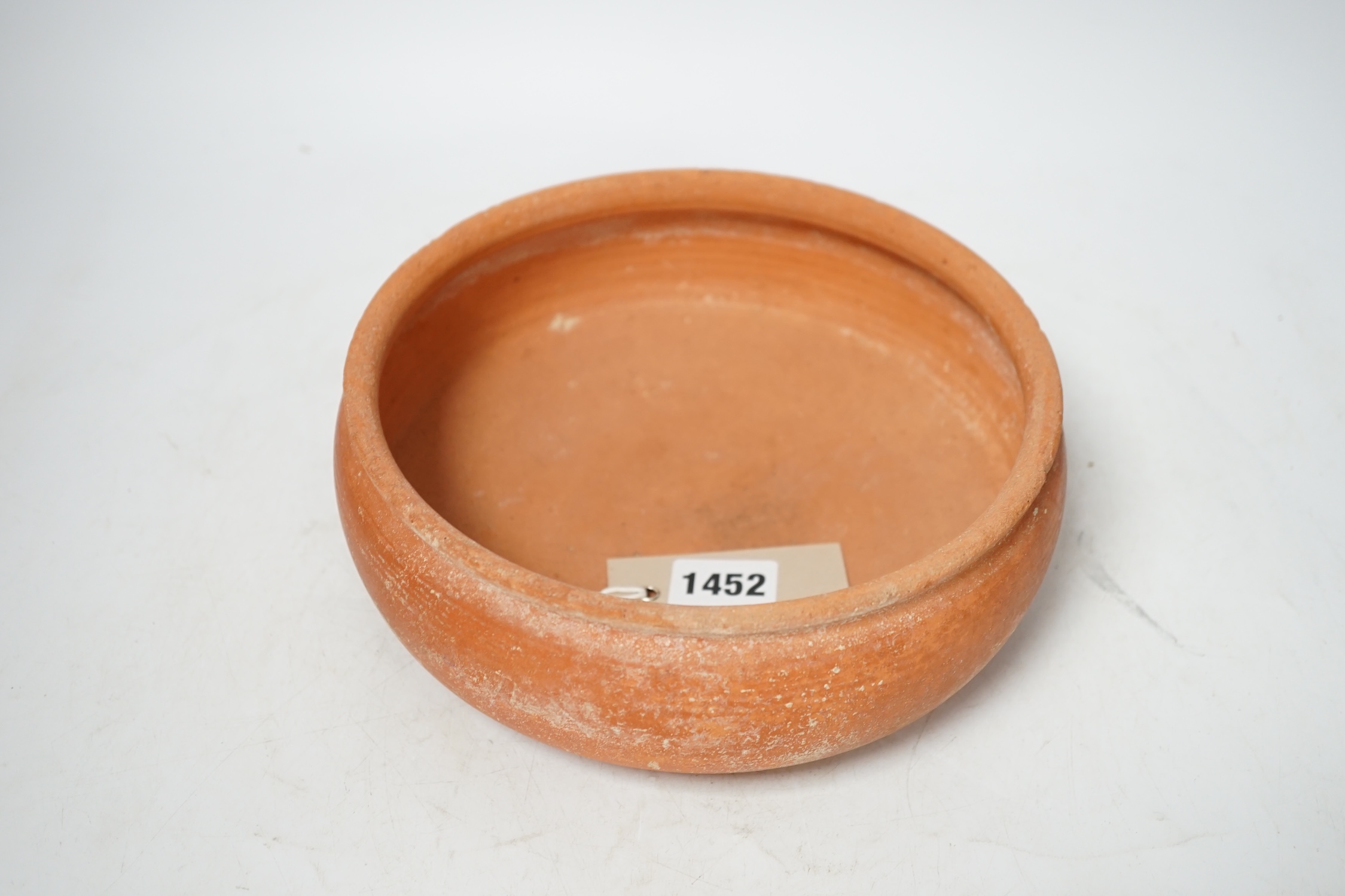 A Roman terra sigillata circular pottery bowl, c.1-300AD, top rim 20cm diameter. Condition - good for age, wear to edge of top rim as to be expected